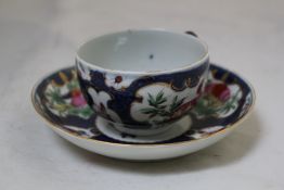 A Worcester blue scale ground coffee cup and saucer, c.1770 decorated with painted exotic birds,