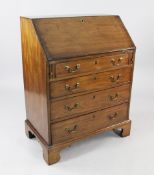 A George III mahogany bureau, with fall front revealing fitted interior over four long graduated