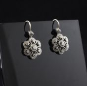 A pair of white gold and diamond drop earrings, of pierced flower head design, with millegrain