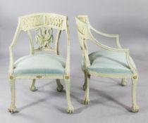 A pair of French Empire style cream and pale blue painted open armchairs, with pierced crest rails,