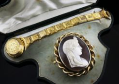 A cased Victorian gold bracelet and gold mounted cameo brooch, the cameo carved with the head of a