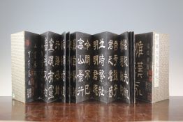 Four Chinese printed concertina books of calligraphy, with brocade covered boards, contained in a