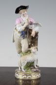 A Meissen group of a boy with a messenger pigeon and a sheep, on a circular base, underglaze blue