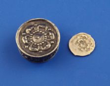 A late 17th century silver circular counter box embossed with a Tudor rose, containing a single