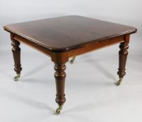 A Victorian style mahogany extending dining table, with three extra leaves, on turned supports and