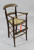 A Victorian child`s beech and cane high chair, H.2ft 10in.