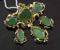 An antique gold and jadeite drop pendant brooch, with ornate scroll borders and set with oval cut