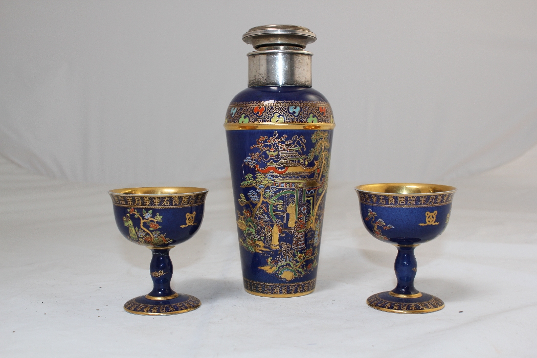 A Carltonware chinoiserie cocktail shaker and a matching pair of goblets, 1920`s, decorated with
