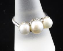 An unmarked white metal and triple natural pearl set half hoop ring, with Anchorcert certificate