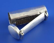 A George III silver cylindrical nutmeg grater, with engraved armorial and hinged lid and arm,