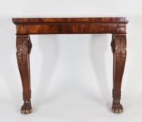 A Regency style mahogany console table, with scroll legs and paw feet, with stiff leaf carved
