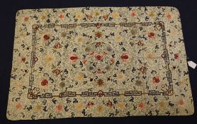 A Chinese embroidered silk table cover, early 20th century, woven with flowers, fruit and scrolling