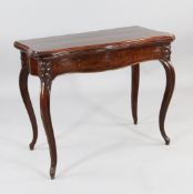 A 19th century French mahogany serpentine card table, with fold over top and scrolling supports, W.