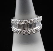 An 18ct white gold and diamond cluster half hoop ring, set with graduated baguette and round cut