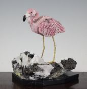 An Argentinian rhodochrosite carved model of a flamingo, on a quartz mineral base, with a trade