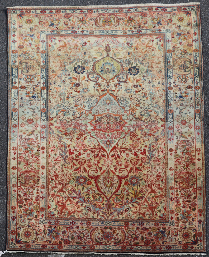 An early 20th century central Persian `Mohtashem` Kashan rug, with field of scrolling foliage and