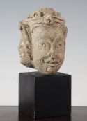 A Sumatran limestone head of a deity, 14.5cm., later plinth