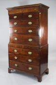 A George III mahogany and marquetry inlaid chest on chest, with two short over three long drawers