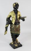 A 19th century carved and gilt polychrome painted blackamoor figure standing holding a circular
