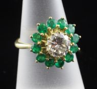 An 18ct gold, emerald and diamond cluster ring, the central diamond weighing approximately 0.90ct,
