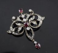 An Edwardian gold and silver, ruby and diamond drop pendant/brooch, of openwork scroll form, 1.