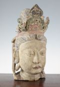 A Chinese painted wood head of Guanyin, Ming dynasty, traces of polychrome, 37cm.