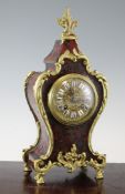 An early 20th century ormolu mounted red boulle work mantel clock, with enamelled tablet numeral