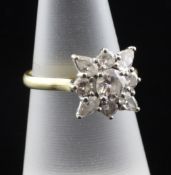 An 18ct gold and diamond cluster flower head ring, set with nine round and pear cut stones, size M.