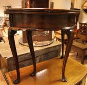 A George III mahogany demi-lune fold over tea table, with wavy apron, on cabriole legs and pointed