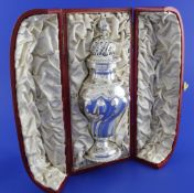 A cased Victorian demi-spiral fluted repousse silver sugar caster by George Fox, of inverted