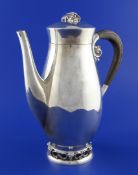 A stylish mid 20th century Mexican sterling silver coffee pot, of baluster form, the foot and