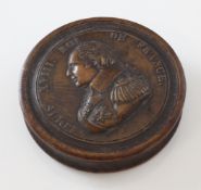 An early 19th century French yew wood press moulded circular snuff box, the cover with King Louis