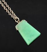 A 9ct gold mounted trapezoid shaped jadeite pendant, on a 9ct gold chain, pendant 1in.