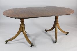 A 19th century mahogany twin pillar dining table, with reeded D ends and two extra leaves, extends