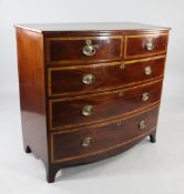 An early 19th century mahogany bowfront chest, fitted two short and three long satinwood banded