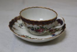 A Worcester polychrome fluted coffee cup and saucer, c.1770, with a gilded scalloped rim, decorated
