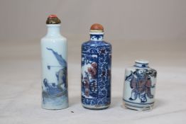 Three Chinese underglaze blue and copper red cylindrical snuff bottles, 1830-1900, the first