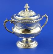 An Edwardian silver gilt two handled pedestal sugar vase and cover, embossed with acanthus leaves