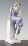 A rare Royal Copenhagen figure `Woman on a Stone Seat`, modelled by Axel Locher in 1903, wearing a