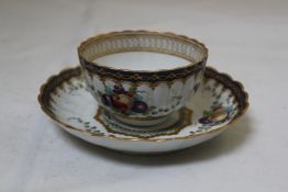 A Worcester polychrome fluted tea bowl and saucer, c.1780 painted with butterflies, fruit, and