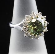 An 18ct white gold and green diamond cluster ring with white diamond set border, the central green