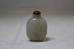 A Chinese celadon jade snuff bottle, 1800/1900, of flattened oblong form, the stone with pale brown
