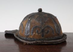 A Mongolian leather covered riding cap, decorated with lappets and scrolls, 31.5cm.