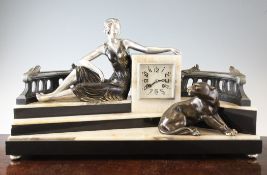 An Art Deco bronzed and silvered spelter mantel clock, modelled as a terrace with seated lady and