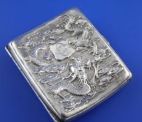 A Chinese silver cigarette case, of concave form, the front with monogrammed appliqué and embossed