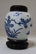 A Chinese blue and white ovoid jar, Kangxi period, painted to one side with ribbon tied objects,