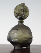 An Art Deco Bohemian green glass `fish` perfume bottle, of olive green colour, moulded in relief