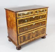 An early 18th century oyster veneered chest of two short and three long graduated long drawers, on