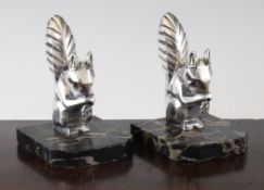 Two pairs of Henri Moreau Art Deco silvered spelter bookends, modelled as squirrels and leaping