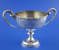 An early 20th century Chinese silver two handled presentation pedestal trophy cup, with foliate